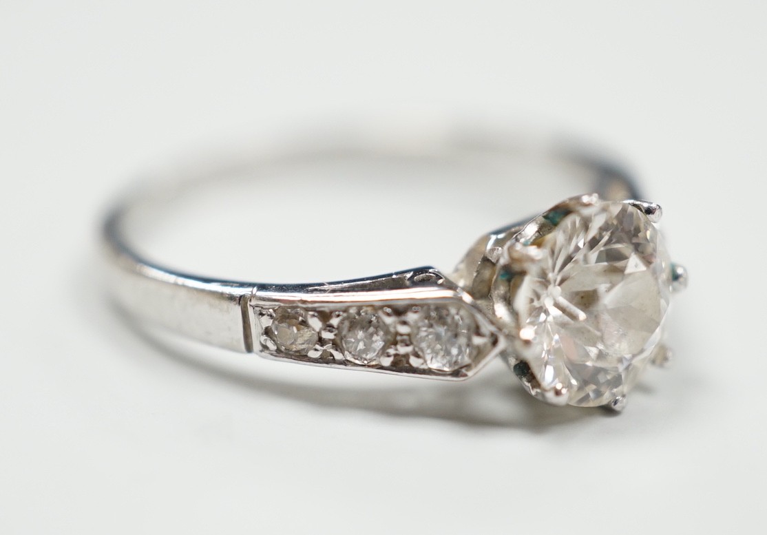 A mid 20th century white metal (stamped Plat) and single stone diamond ring, with diamond set shoulders, size J, gross 2.6 grams